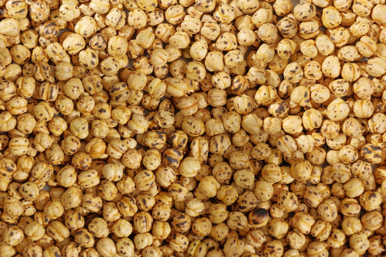 Close-up of roasted chickpeas offering a textured and nutty appearance.